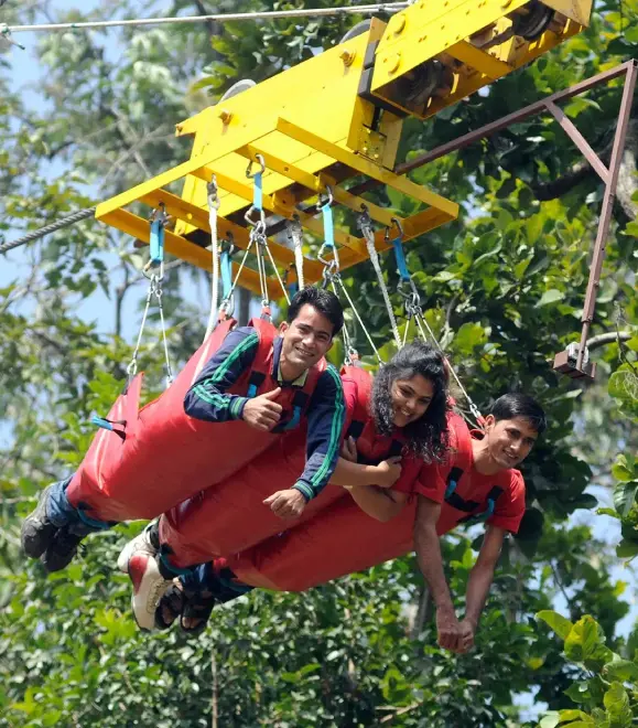 Couple experiencing the thrill of a flying box ride