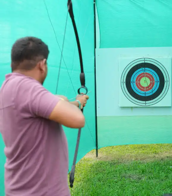 Beginner practicing archery at outdoor adventure zone